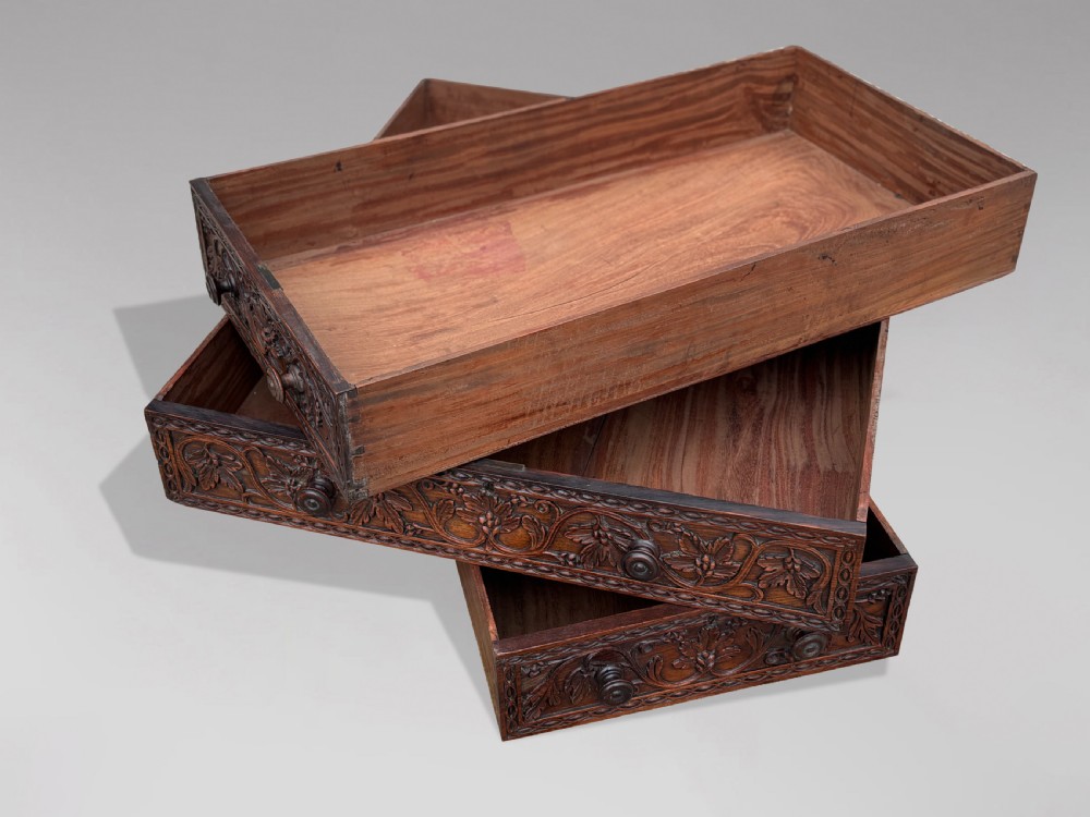 Nineteenth-century Anglo-Indian carved padauk partners desk featuring intricate foliate relief carvings across the pedestal drawers and side panels on turned bun feet. View VIII
