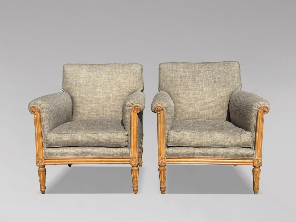 A pair of 19th-century French Louis XVI style armchairs featuring carved wooden frames, fluted legs, and neutral grey woven upholstery. View II