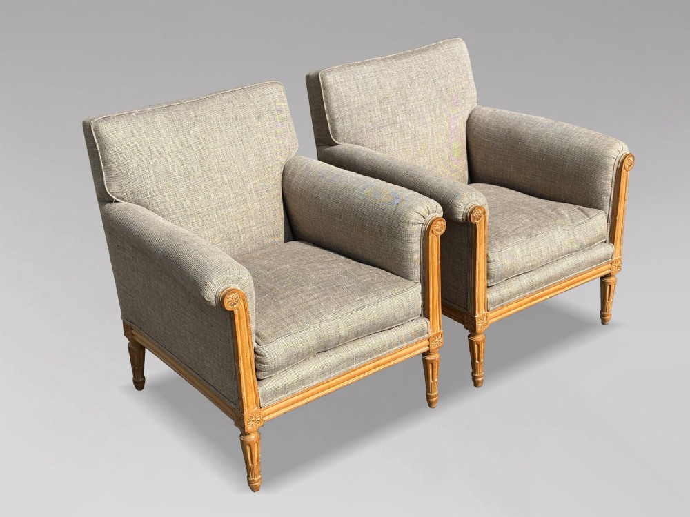 A pair of 19th-century French Louis XVI style armchairs featuring carved wooden frames, fluted legs, and neutral grey woven upholstery. View III