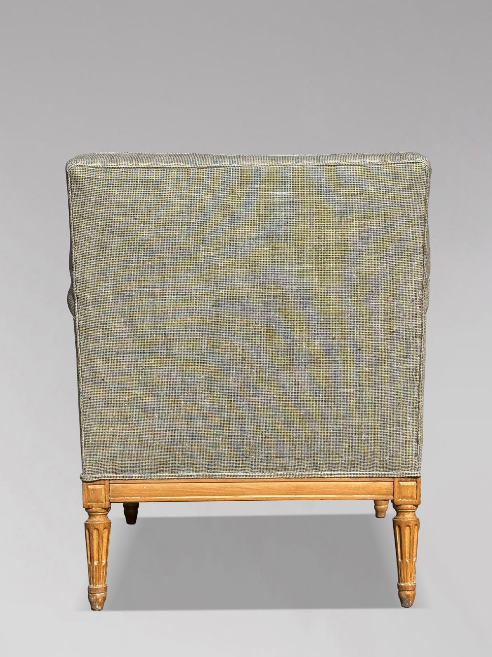 A pair of 19th-century French Louis XVI style armchairs featuring carved wooden frames, fluted legs, and neutral grey woven upholstery. View V