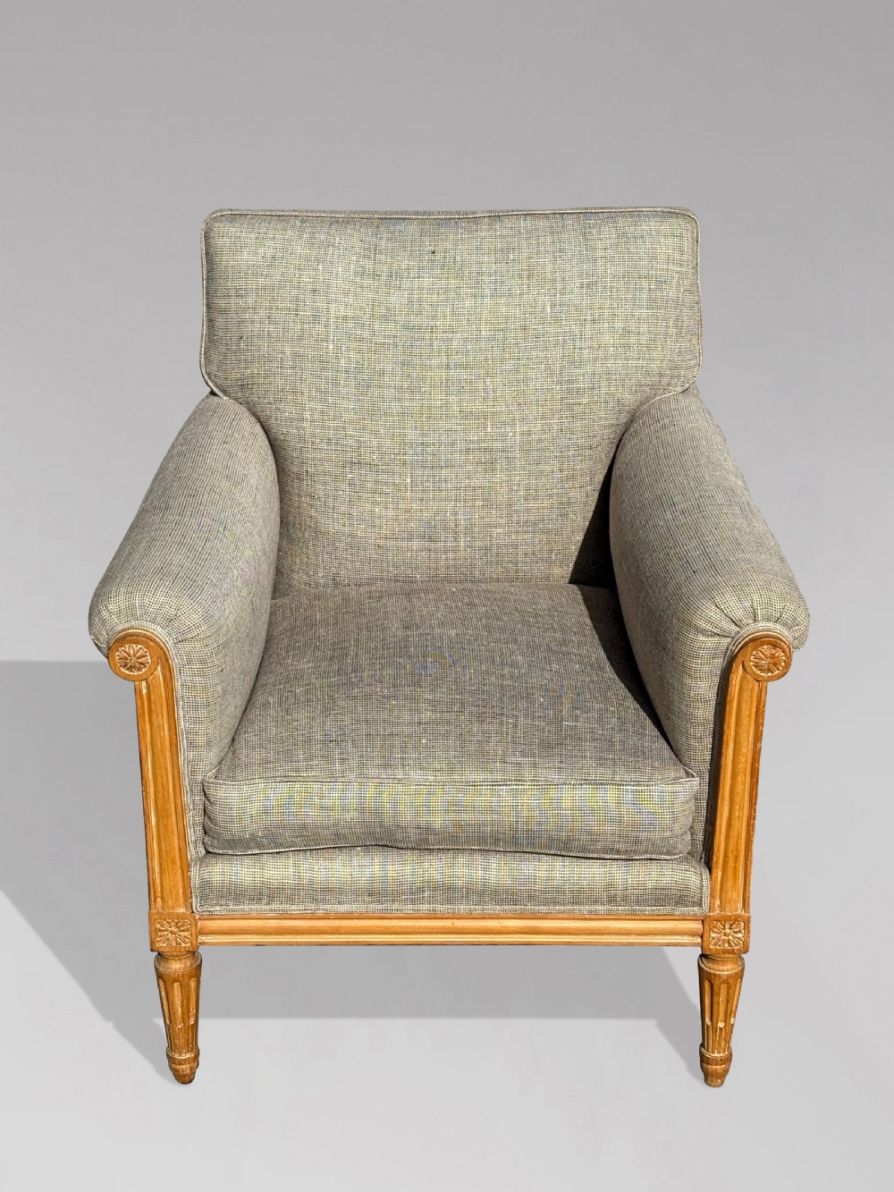 A pair of 19th-century French Louis XVI style armchairs featuring carved wooden frames, fluted legs, and neutral grey woven upholstery. View VIII