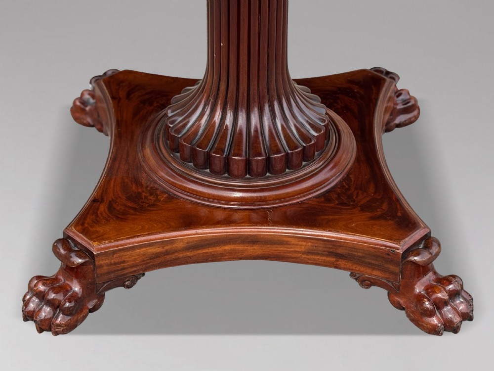 A 19th-century French Charles X mahogany centre table with a circular top, fluted central pedestal, and quadform base on carved feet. View III
