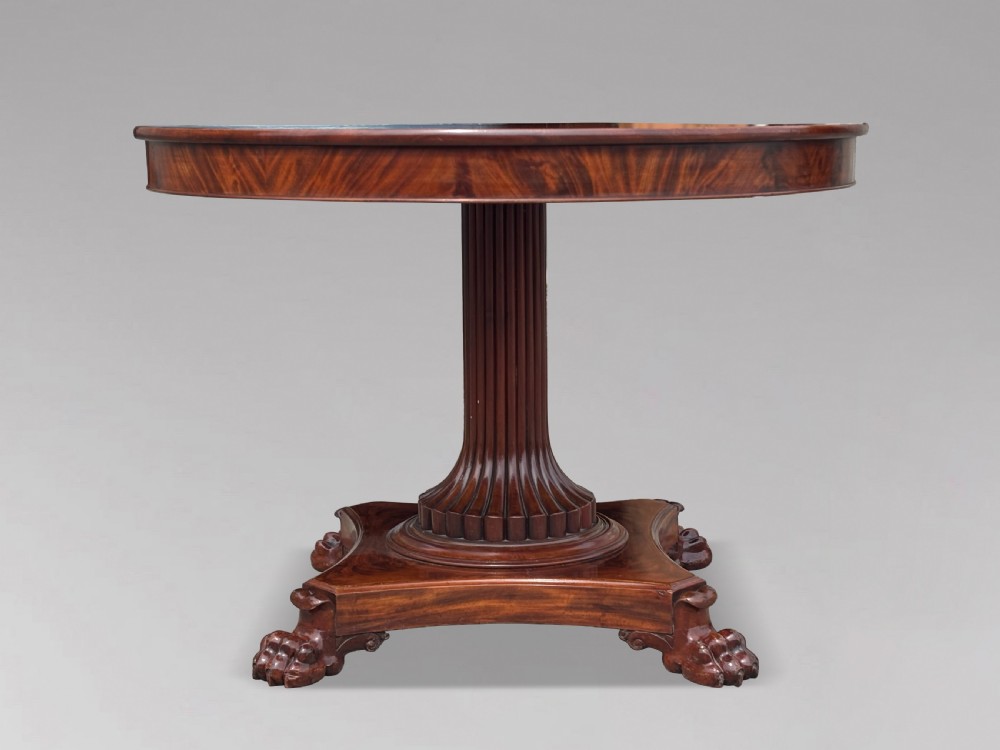 A 19th-century French Charles X mahogany centre table with a circular top, fluted central pedestal, and quadform base on carved feet. View IV