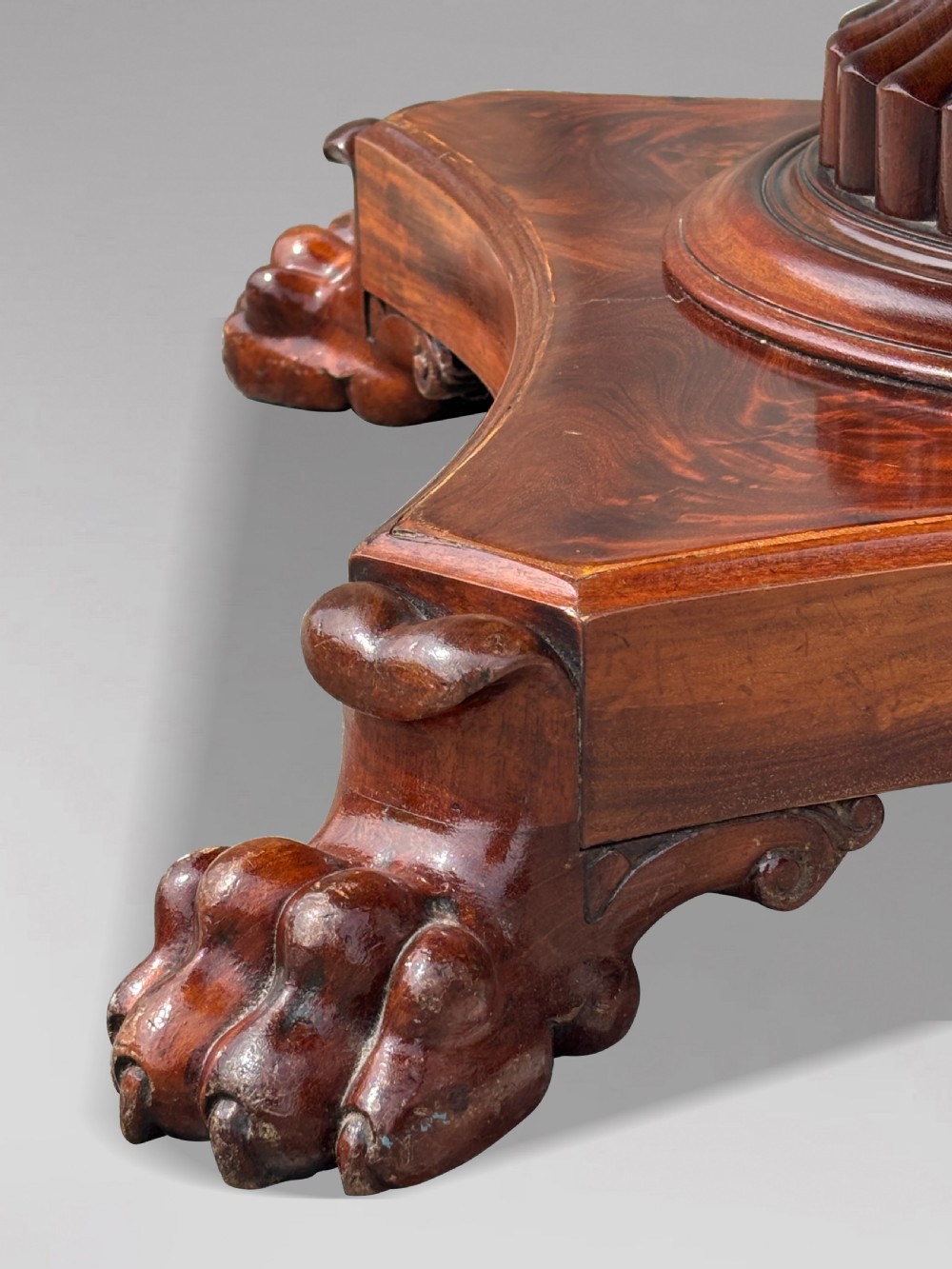 A 19th-century French Charles X mahogany centre table with a circular top, fluted central pedestal, and quadform base on carved feet. View XI