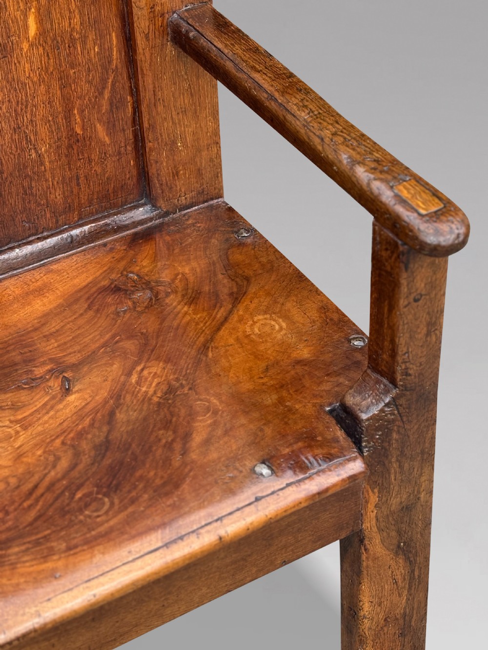 An 18th-century Georgian high-back settle crafted from oak and elm featuring a panelled back and wooden armrests. View IX