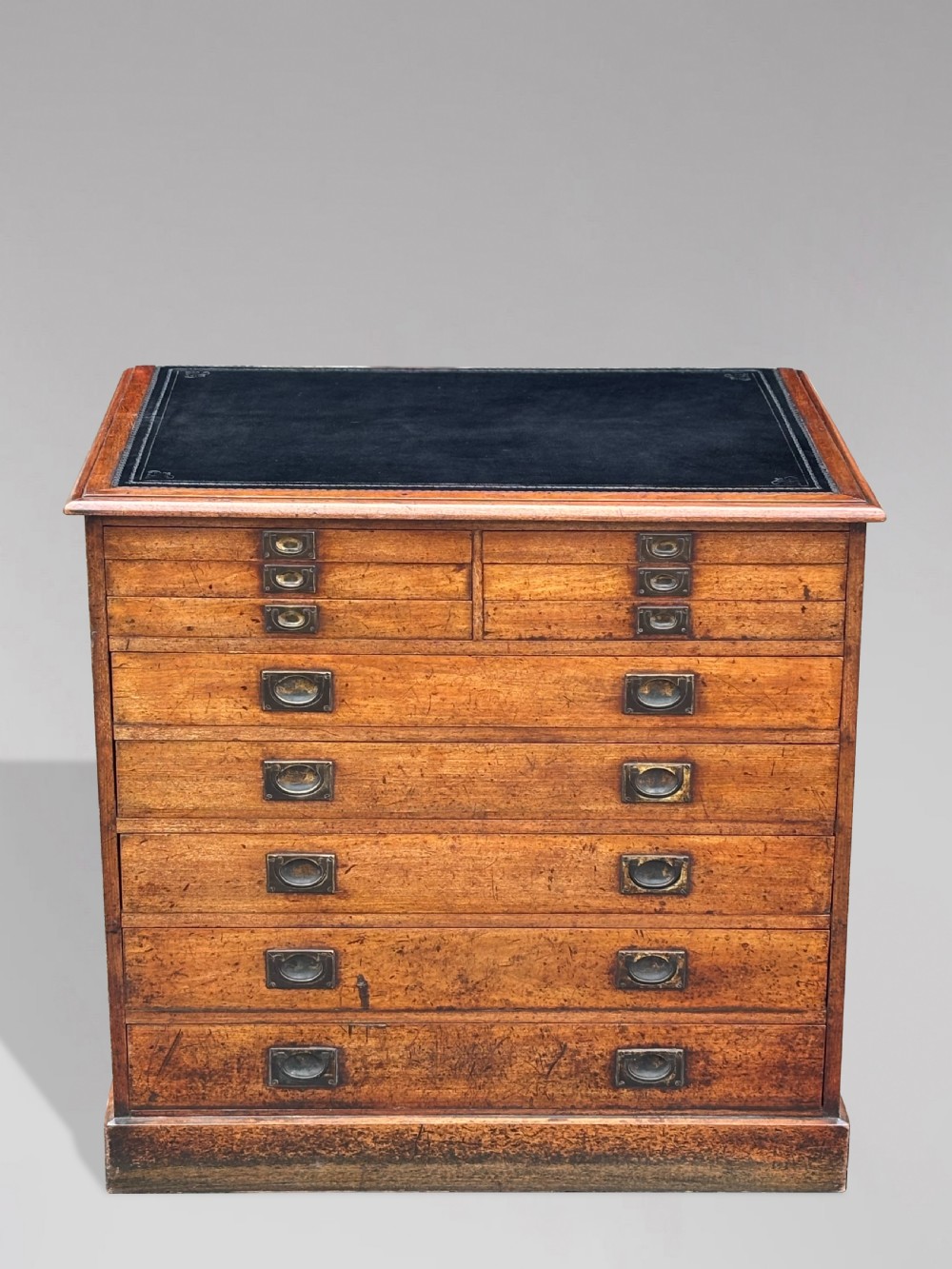 A nineteenth-century mahogany campaign filing cabinet featuring multiple drawers with flush brass handles and a dark leather inset top surface.