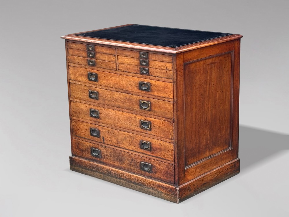 A nineteenth-century mahogany campaign filing cabinet featuring multiple drawers with flush brass handles and a dark leather inset top surface. View II