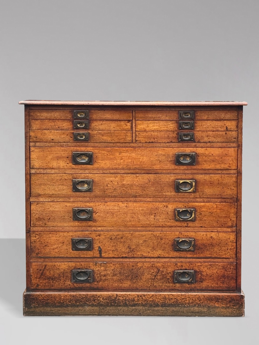 A nineteenth-century mahogany campaign filing cabinet featuring multiple drawers with flush brass handles and a dark leather inset top surface. View VII
