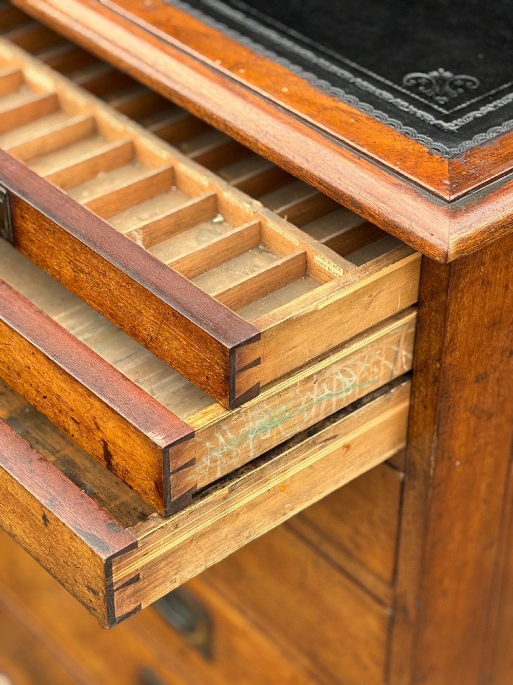 A nineteenth-century mahogany campaign filing cabinet featuring multiple drawers with flush brass handles and a dark leather inset top surface. View VIII