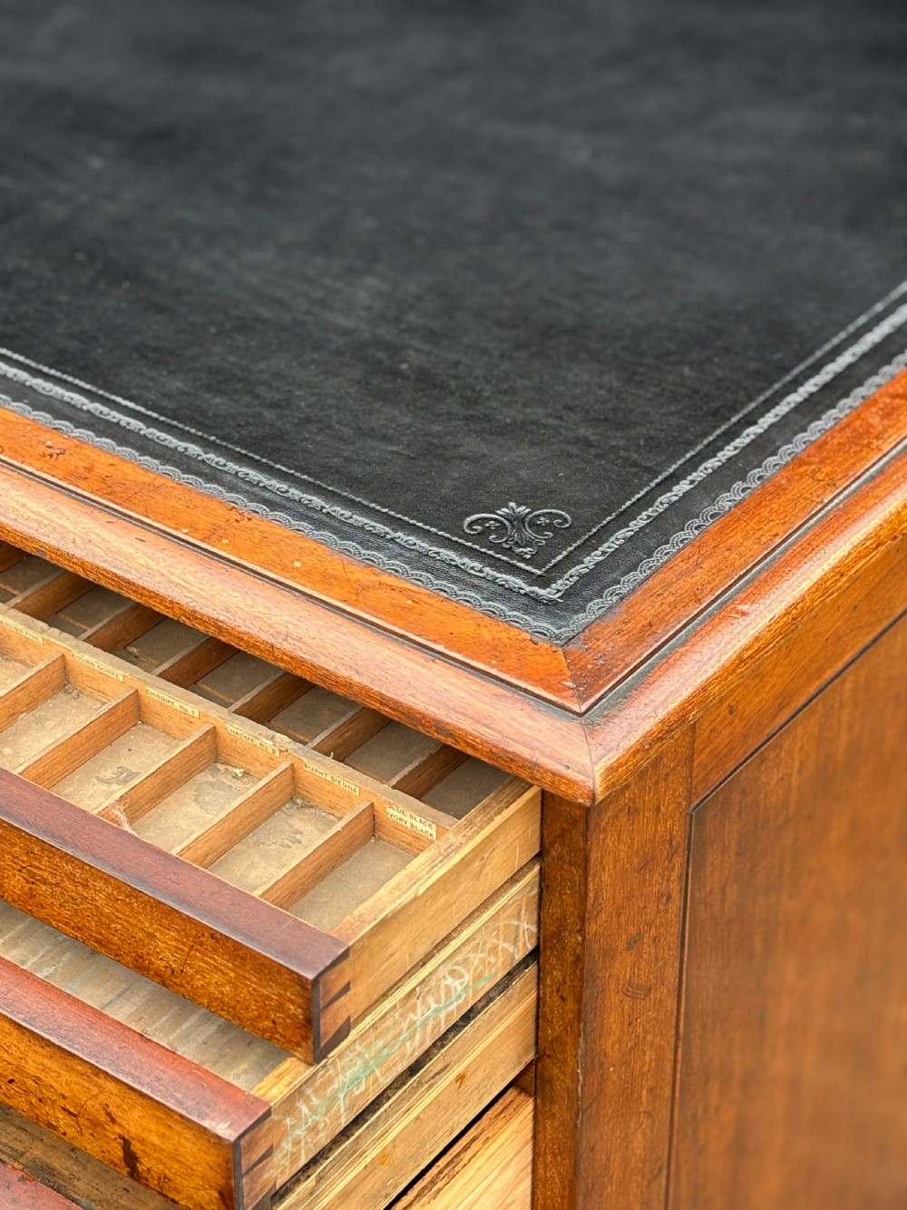 A nineteenth-century mahogany campaign filing cabinet featuring multiple drawers with flush brass handles and a dark leather inset top surface. View X