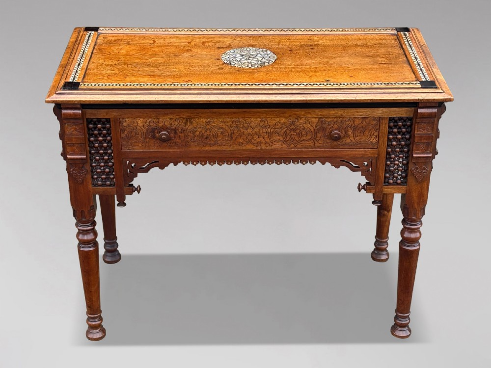 A late 19th-century Aesthetic Movement side table featuring carved wood, a central mother-of-pearl inlay medallion, turned spindle side panels, and turned legs. View II