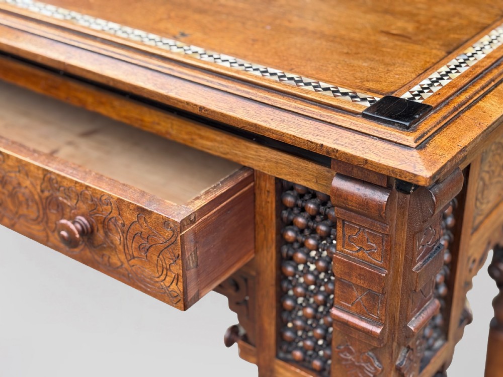 A late 19th-century Aesthetic Movement side table featuring carved wood, a central mother-of-pearl inlay medallion, turned spindle side panels, and turned legs. View IV