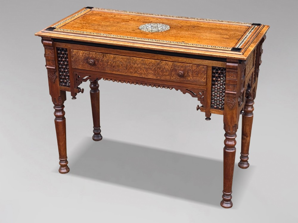 A late 19th-century Aesthetic Movement side table featuring carved wood, a central mother-of-pearl inlay medallion, turned spindle side panels, and turned legs. View V