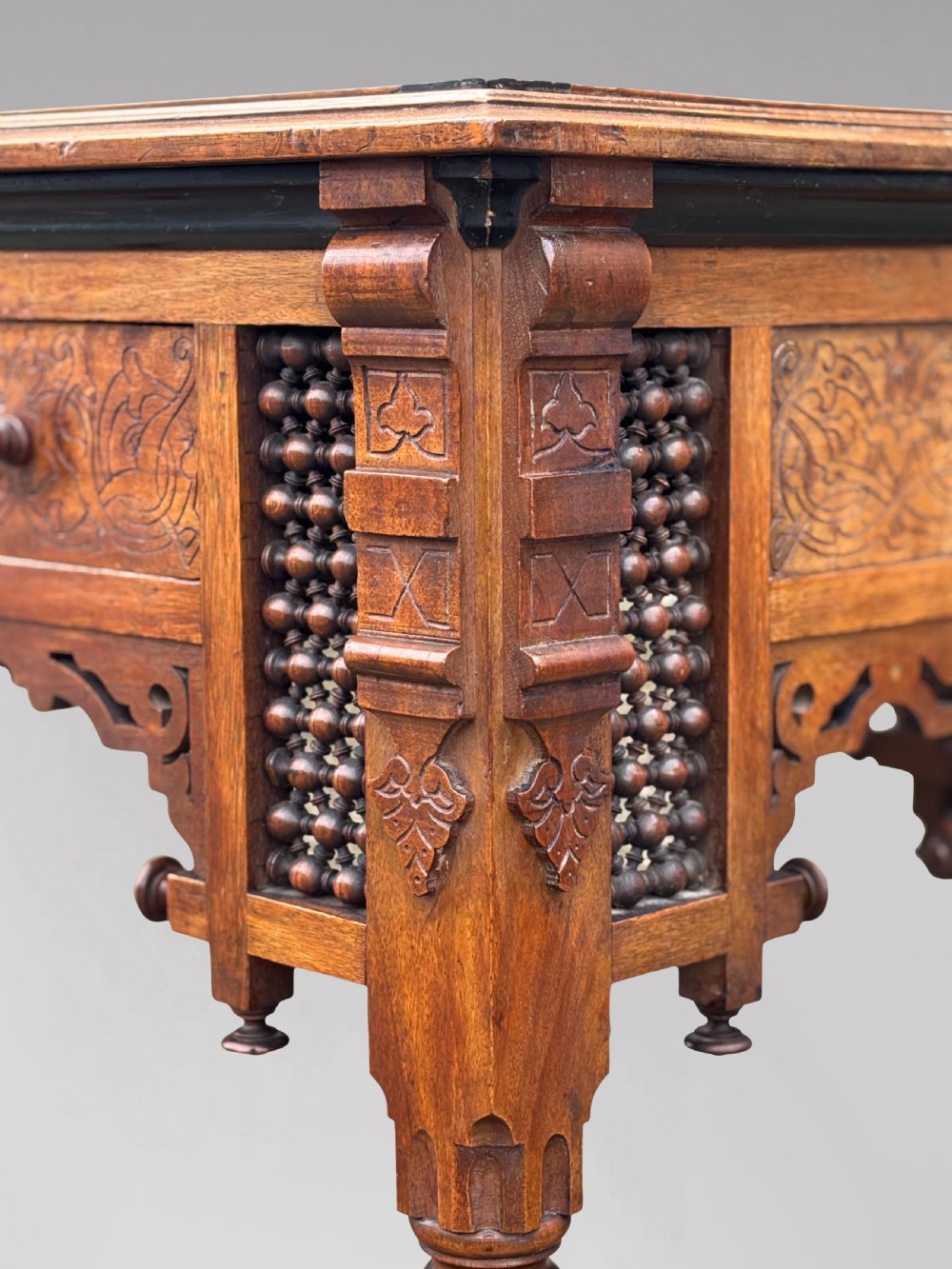 A late 19th-century Aesthetic Movement side table featuring carved wood, a central mother-of-pearl inlay medallion, turned spindle side panels, and turned legs. View VI