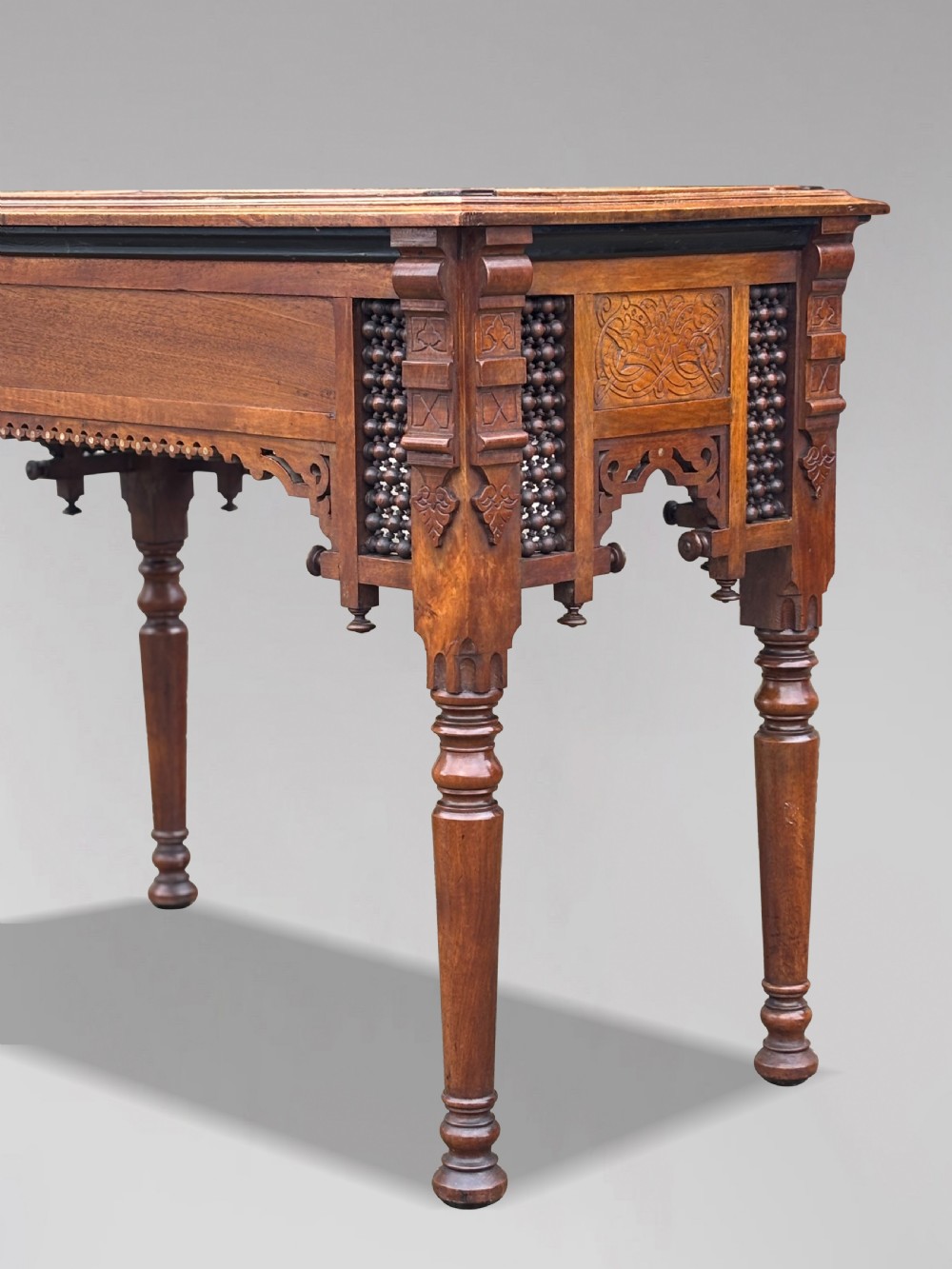 A late 19th-century Aesthetic Movement side table featuring carved wood, a central mother-of-pearl inlay medallion, turned spindle side panels, and turned legs. View IX