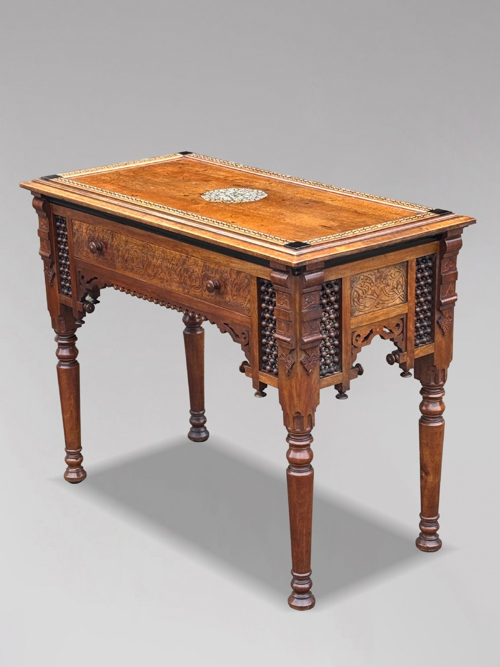 A late 19th-century Aesthetic Movement side table featuring carved wood, a central mother-of-pearl inlay medallion, turned spindle side panels, and turned legs. View XIII