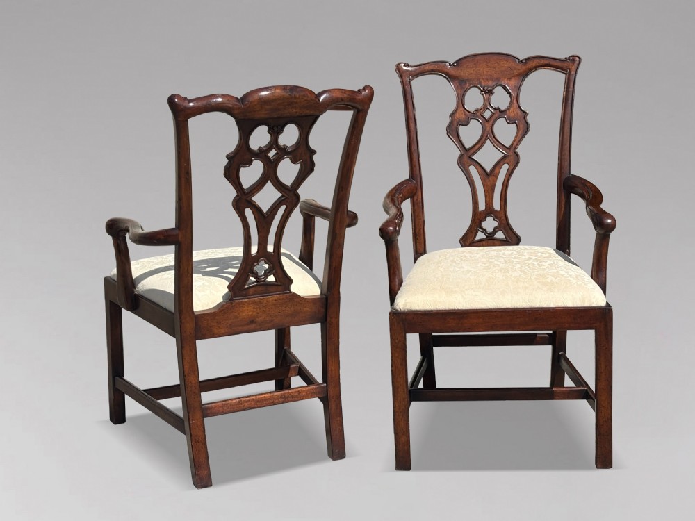 A set of six Edwardian mahogany dining chairs featuring pierced carved back splats, serpentine top rails, cream upholstered seats, and straight square legs with H-stretchers. View III