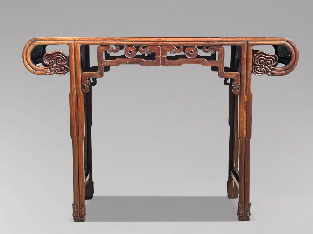 A late nineteenth-century Chinese Hongmu altar table featuring everted flange ends, decorative openwork carved aprons, and three amboyna wood panels inlaid on the top surface. View IV