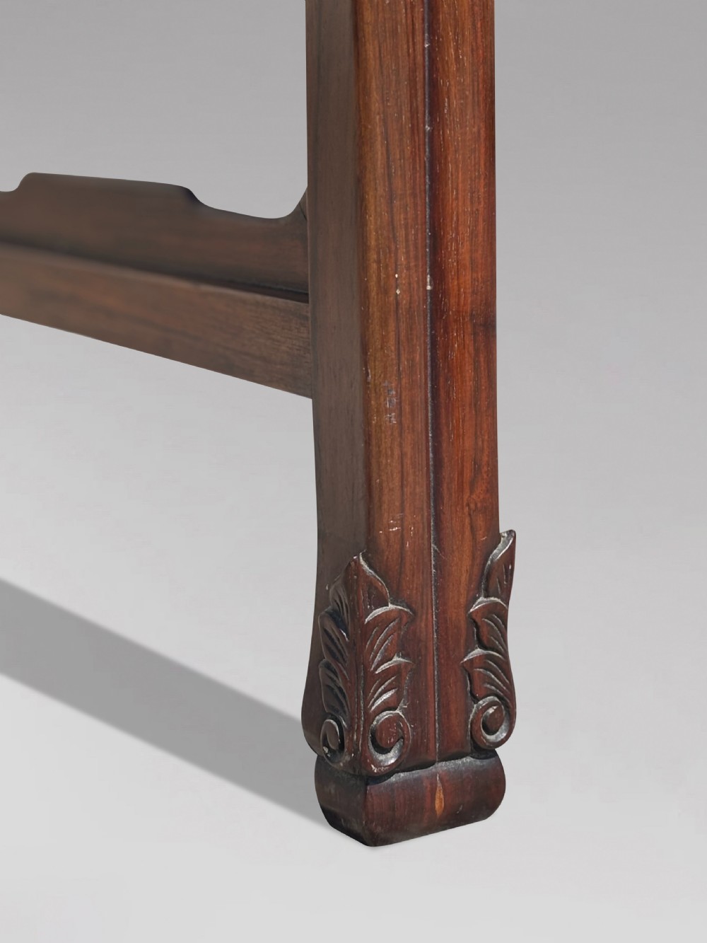 A late nineteenth-century Chinese Hongmu altar table featuring everted flange ends, decorative openwork carved aprons, and three amboyna wood panels inlaid on the top surface. View VII