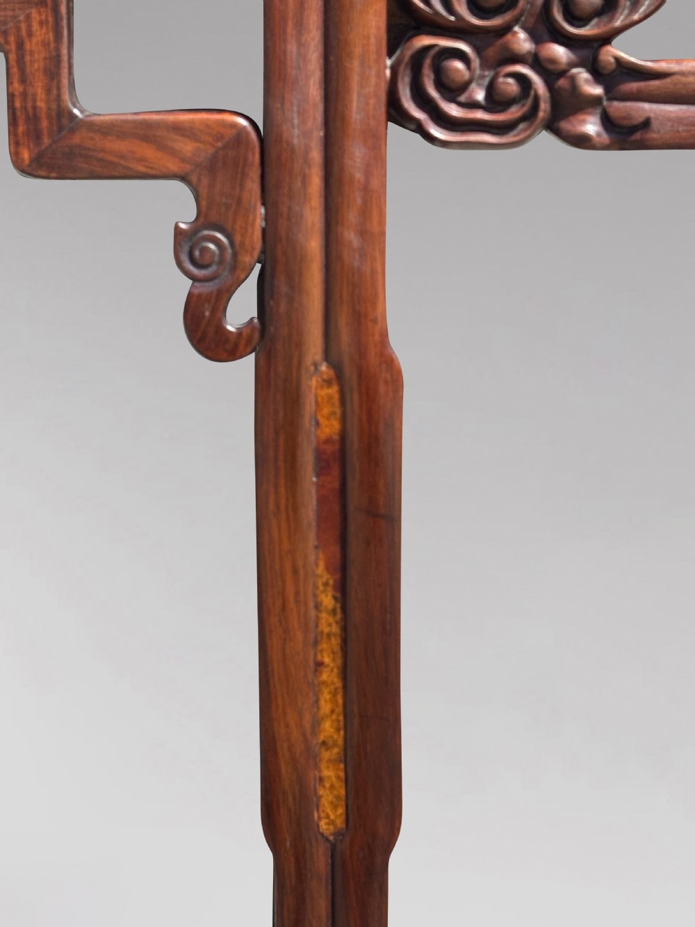 A late nineteenth-century Chinese Hongmu altar table featuring everted flange ends, decorative openwork carved aprons, and three amboyna wood panels inlaid on the top surface. View VIII