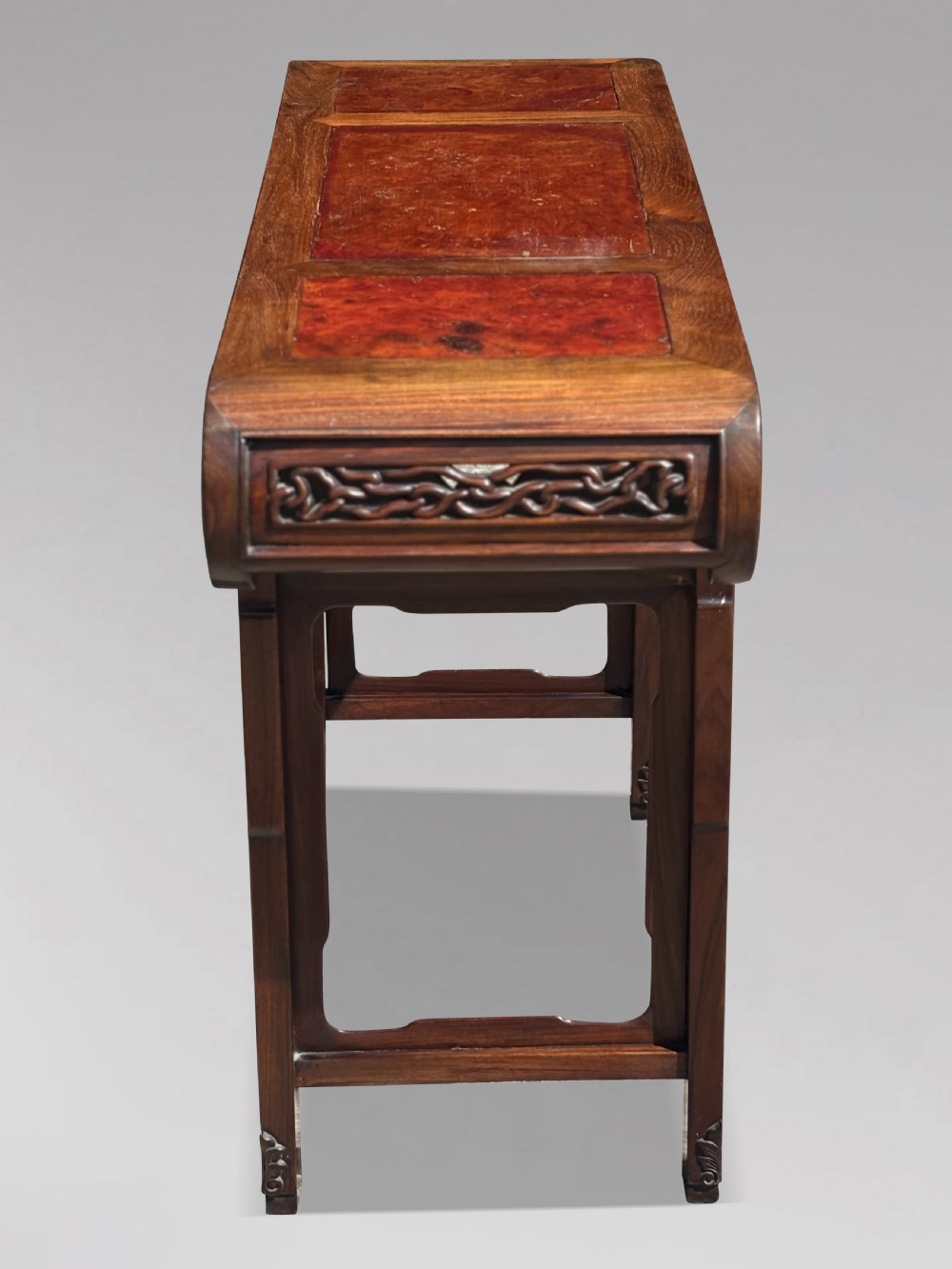 A late nineteenth-century Chinese Hongmu altar table featuring everted flange ends, decorative openwork carved aprons, and three amboyna wood panels inlaid on the top surface. View IX