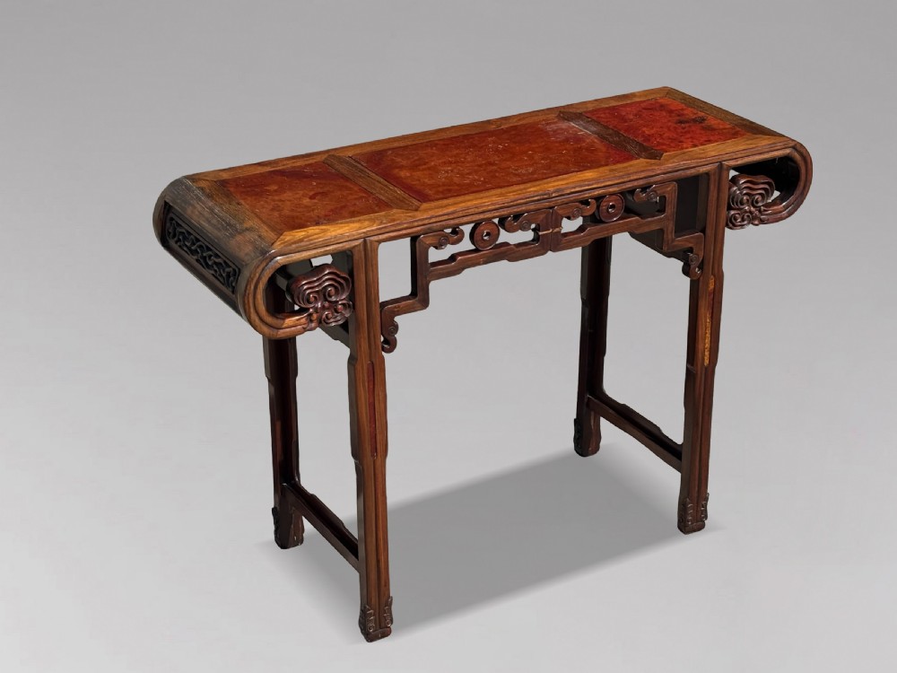 A late nineteenth-century Chinese Hongmu altar table featuring everted flange ends, decorative openwork carved aprons, and three amboyna wood panels inlaid on the top surface. View XI