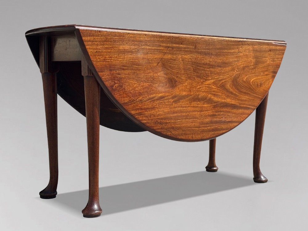 An 18th-century George II mahogany drop-leaf dining table with a round top and tapered legs ending in pad feet. View III