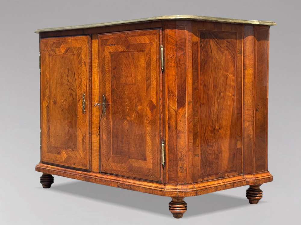 An 18th-century Maltese walnut cabinet with geometric parquetry inlays on the top and two panelled doors flanked by rounded corners on turned feet. View III