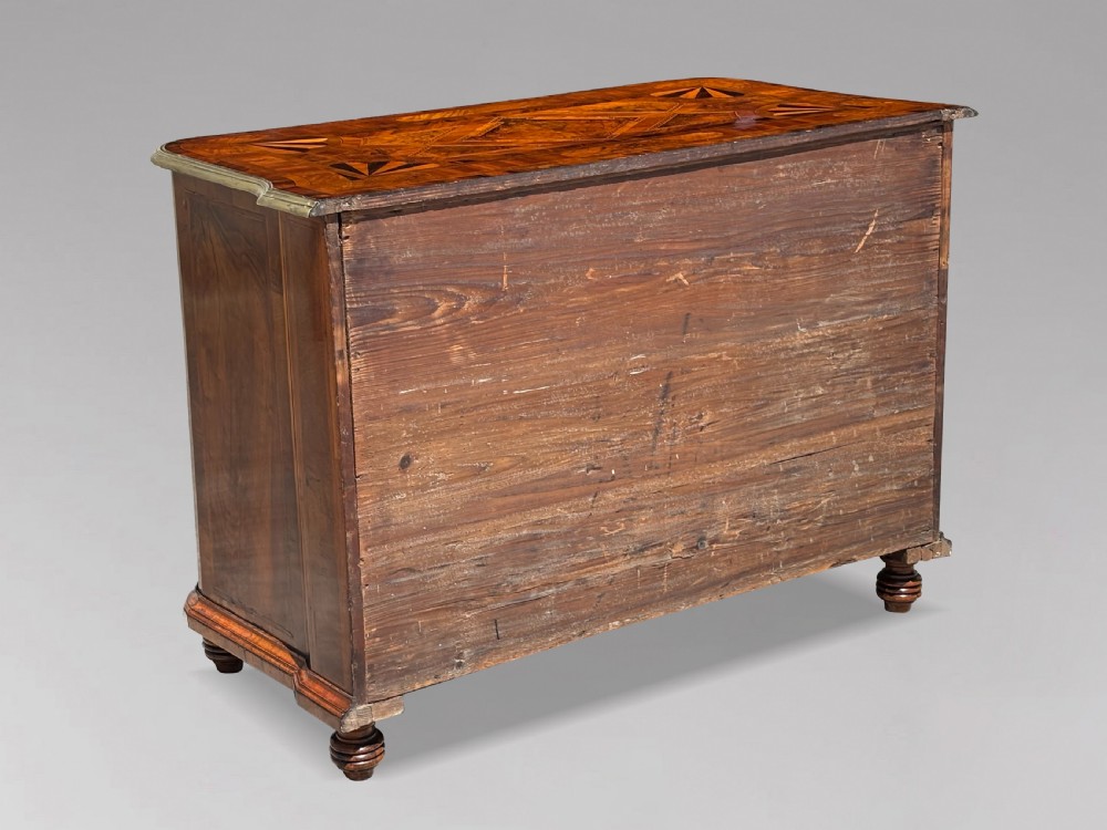 An 18th-century Maltese walnut cabinet with geometric parquetry inlays on the top and two panelled doors flanked by rounded corners on turned feet. View VII