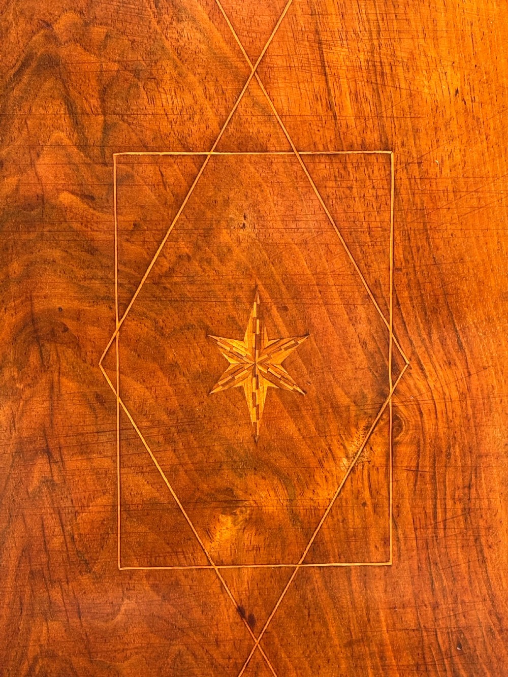 An 18th-century Maltese walnut cabinet with geometric parquetry inlays on the top and two panelled doors flanked by rounded corners on turned feet. View XVI