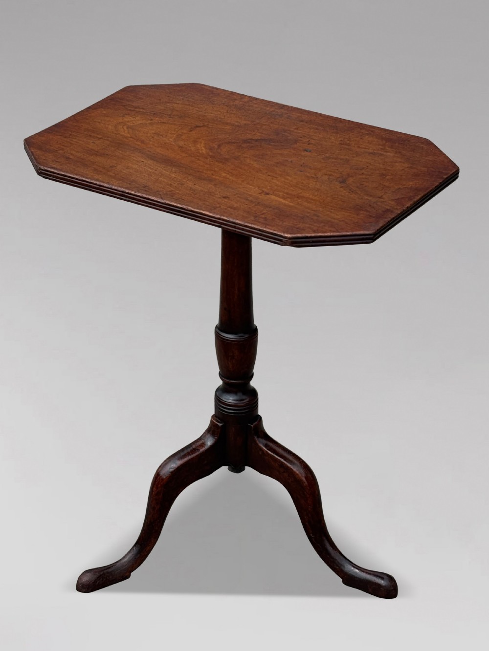 An 18th-century George III mahogany tripod table featuring an octagonal top, a central turned column, and three cabriole legs. View VII