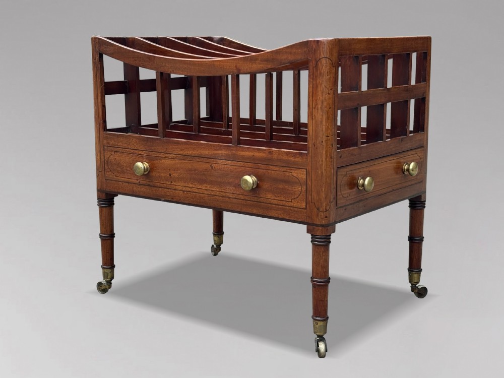 An 18th-century George III mahogany canterbury featuring slatted divisions, lower drawers with brass knobs, and turned legs on brass castors. View II