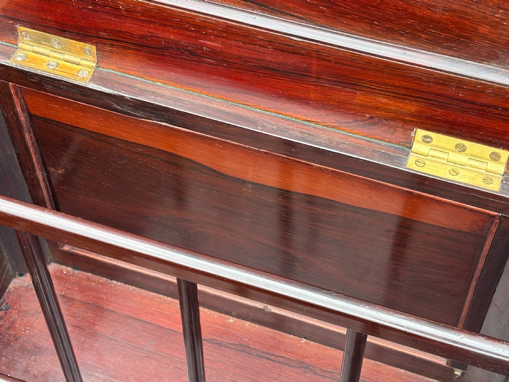 A Victorian rosewood piano stool featuring a square tapestry-upholstered top with green velvet edging, carved fretwork side panels, corner barley twist columns, and bun feet. View VI