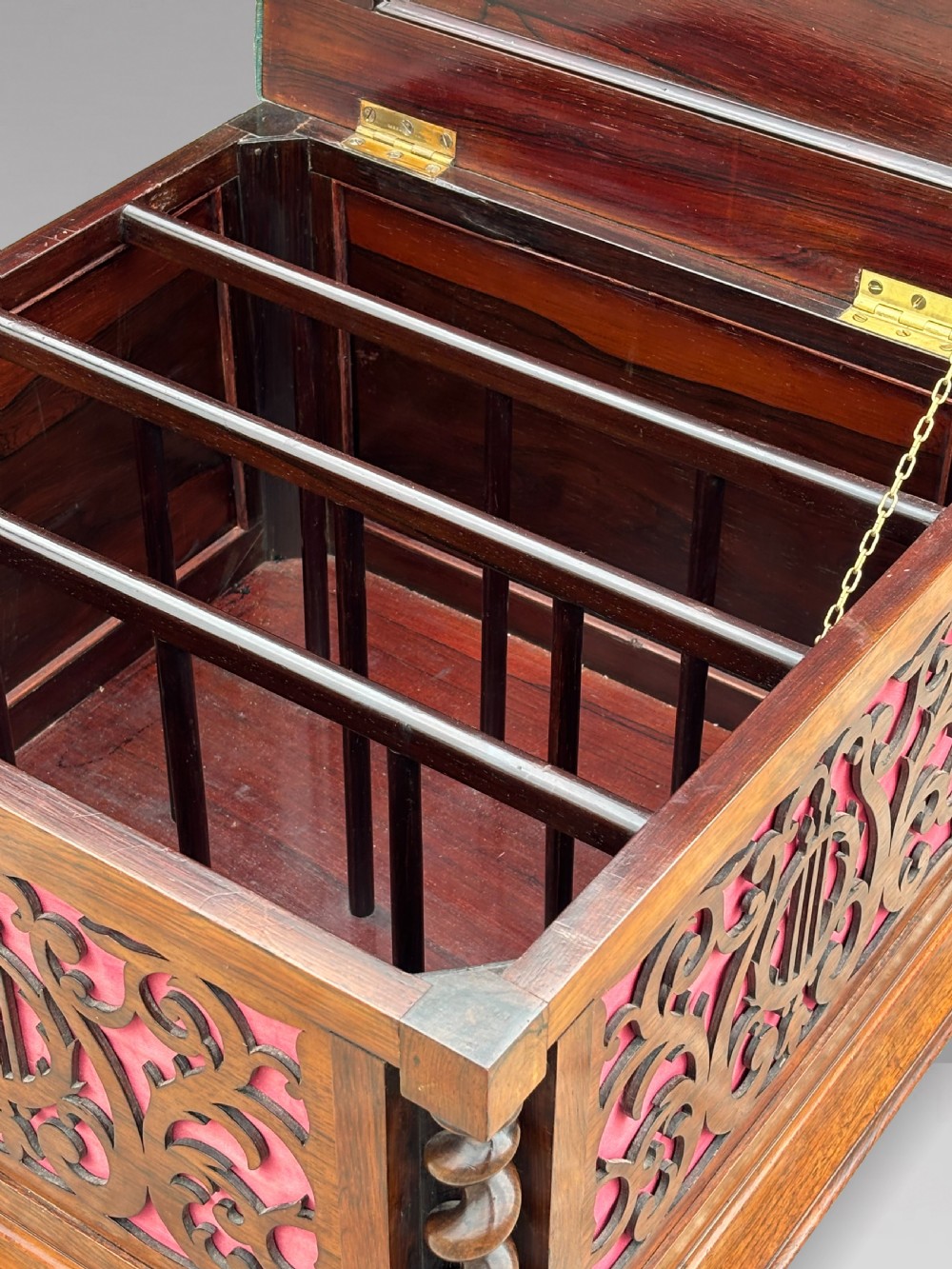 A Victorian rosewood piano stool featuring a square tapestry-upholstered top with green velvet edging, carved fretwork side panels, corner barley twist columns, and bun feet. View VII