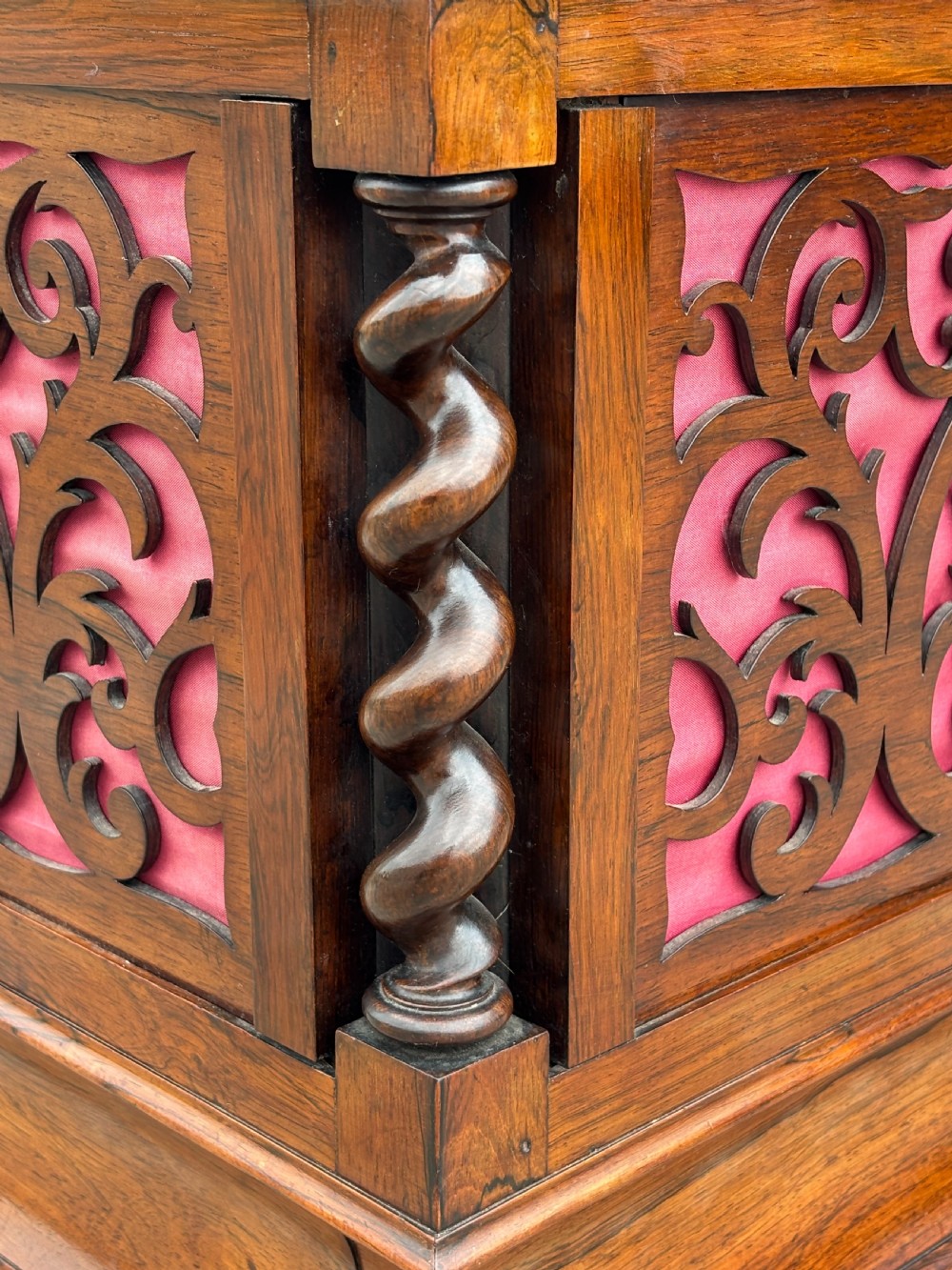 A Victorian rosewood piano stool featuring a square tapestry-upholstered top with green velvet edging, carved fretwork side panels, corner barley twist columns, and bun feet. View VIII