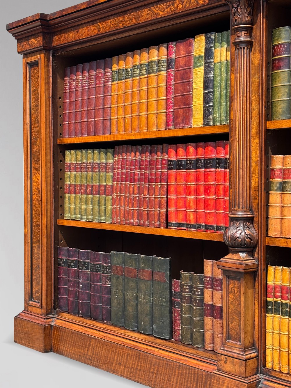 A low 19th-century William IV open bookcase crafted from burr walnut with two shelf sections flanked by carved pilasters. View II