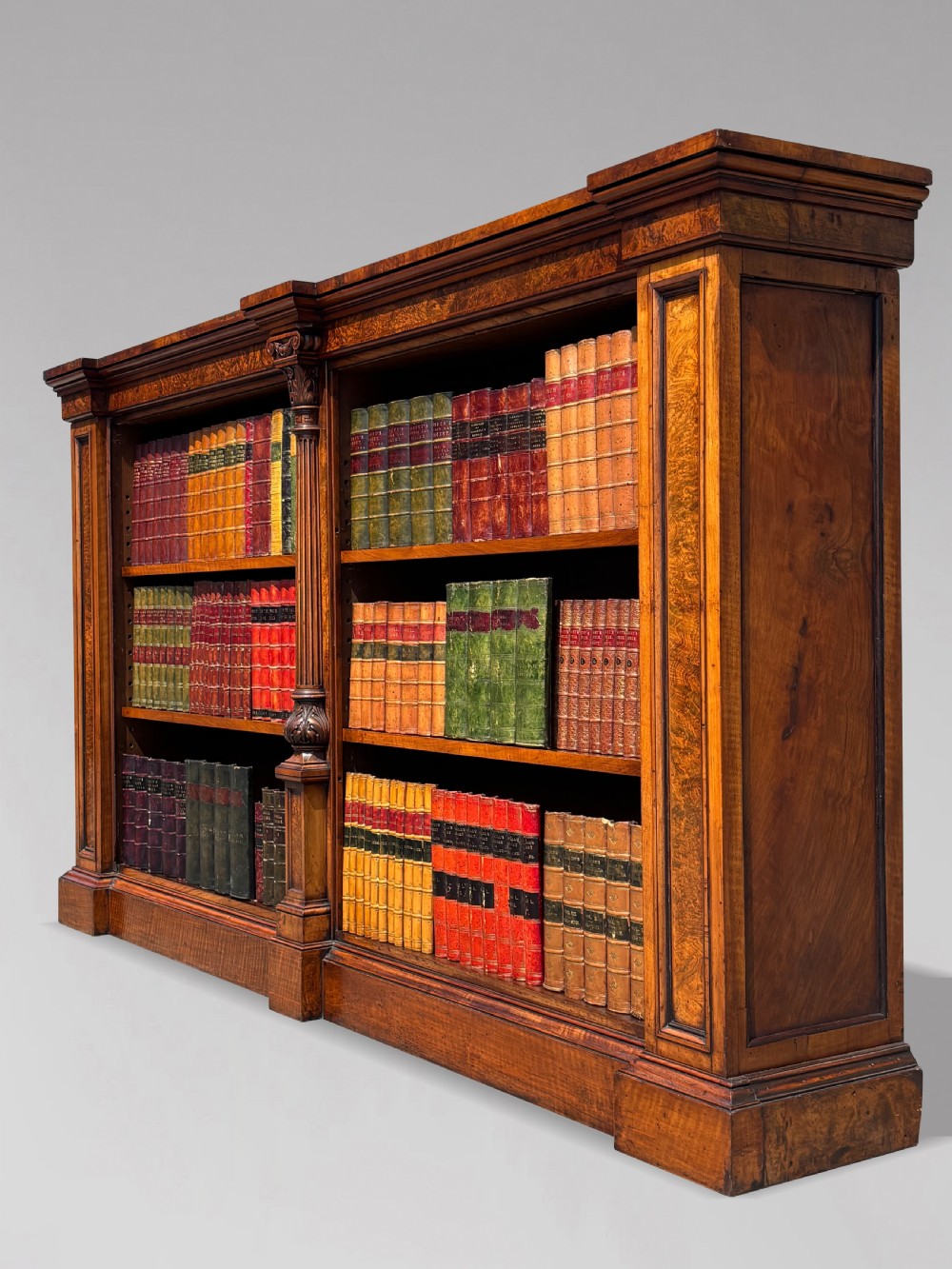 A low 19th-century William IV open bookcase crafted from burr walnut with two shelf sections flanked by carved pilasters. View IV