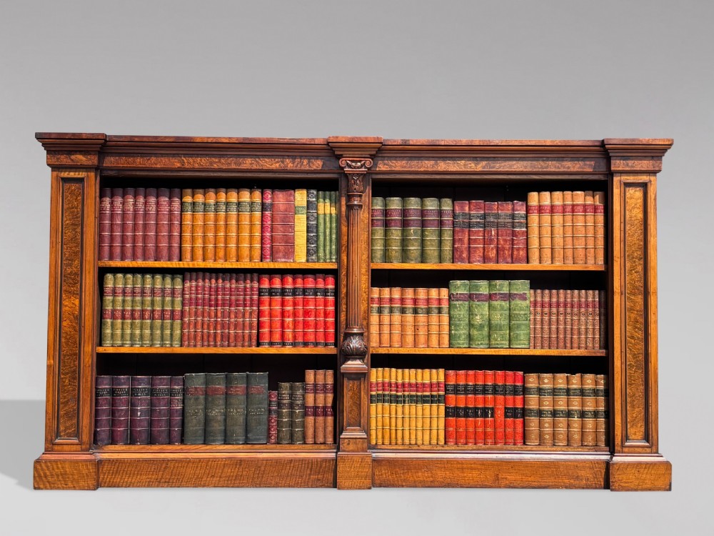 A low 19th-century William IV open bookcase crafted from burr walnut with two shelf sections flanked by carved pilasters. View IX
