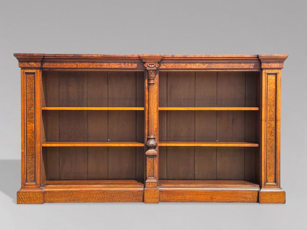 A low 19th-century William IV open bookcase crafted from burr walnut with two shelf sections flanked by carved pilasters. View X