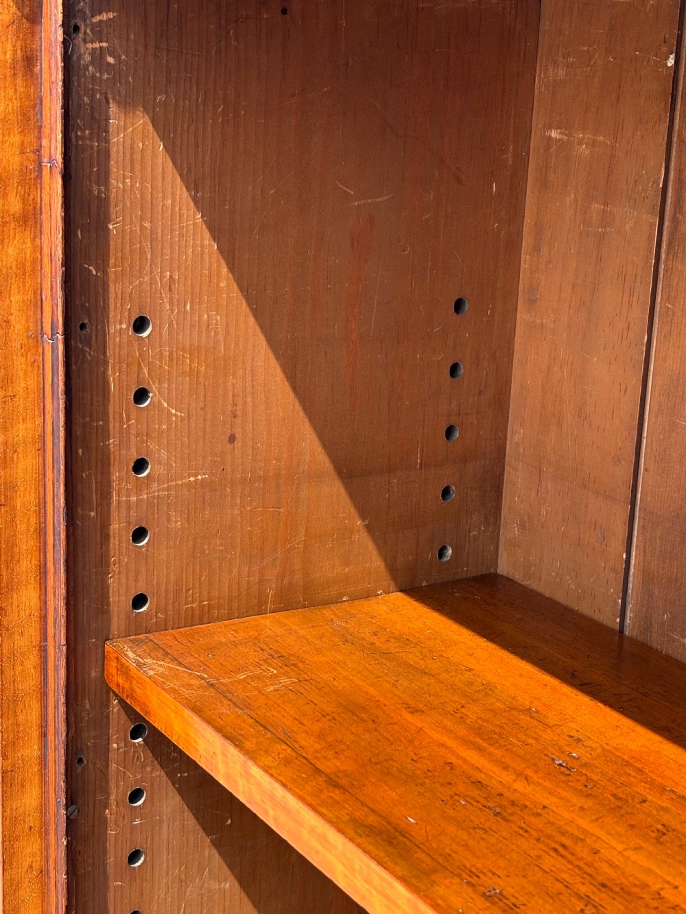 A low 19th-century William IV open bookcase crafted from burr walnut with two shelf sections flanked by carved pilasters. View XI