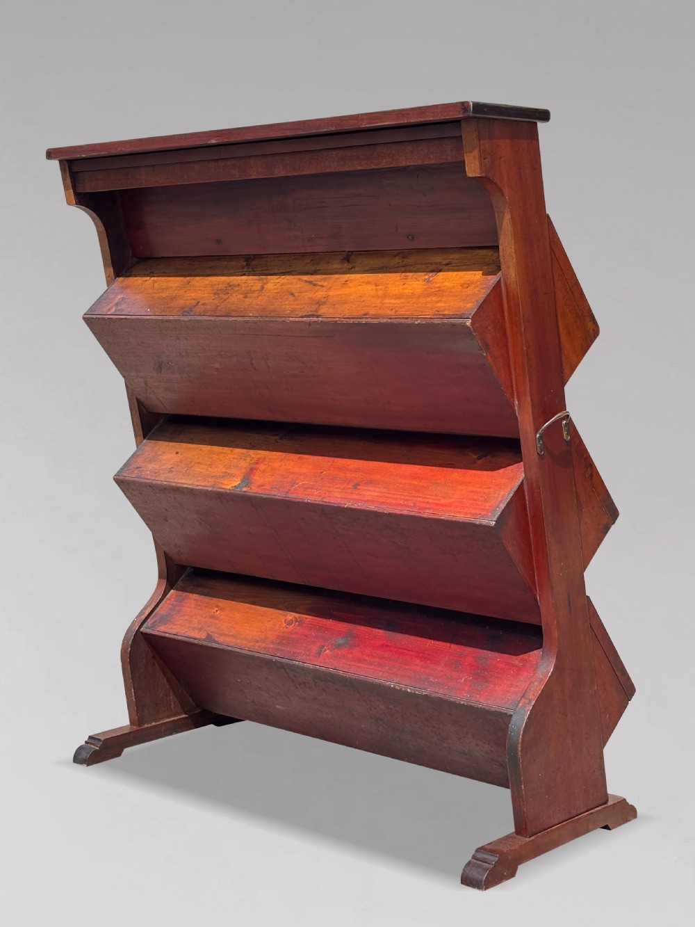 A late 19th-century mahogany three-tiered biscuit display cabinet featuring angled glass fronts, brass handles, and a painted advertising header for Mackenzies Biscuits. View V