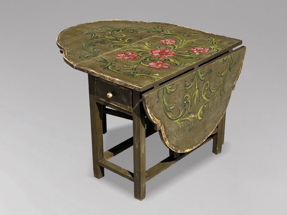 An early 20th-century Italian oval drop-leaf table painted in olive green with hand-painted red floral and green foliage motifs across the top surface. View III