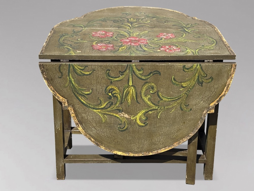 An early 20th-century Italian oval drop-leaf table painted in olive green with hand-painted red floral and green foliage motifs across the top surface. View VI