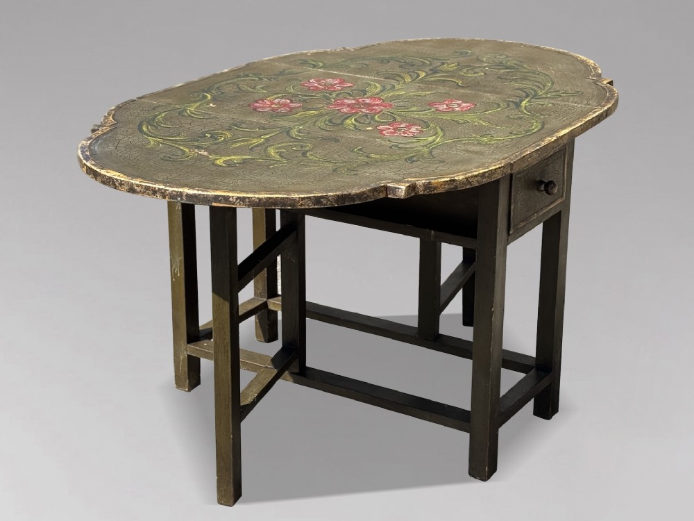 An early 20th-century Italian oval drop-leaf table painted in olive green with hand-painted red floral and green foliage motifs across the top surface. View VII