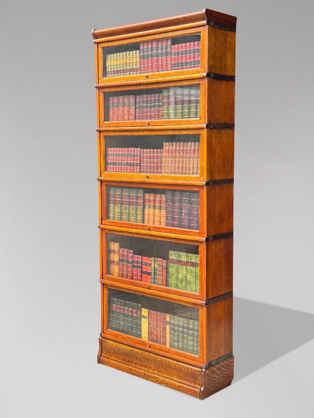 A tall late 19th-century six-tier oak Globe Wernicke bookcase with glazed up-and-over doors. View II