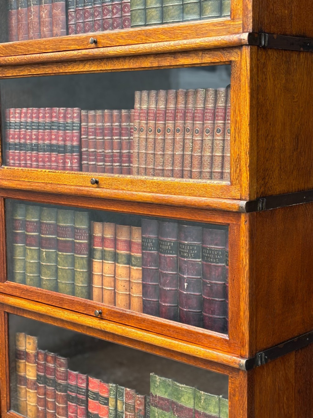 A tall late 19th-century six-tier oak Globe Wernicke bookcase with glazed up-and-over doors. View III
