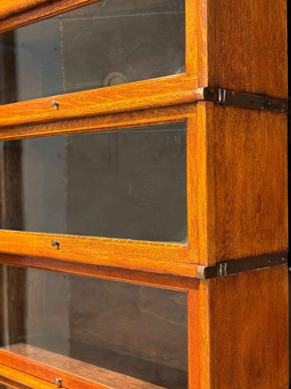 A tall late 19th-century six-tier oak Globe Wernicke bookcase with glazed up-and-over doors. View IV