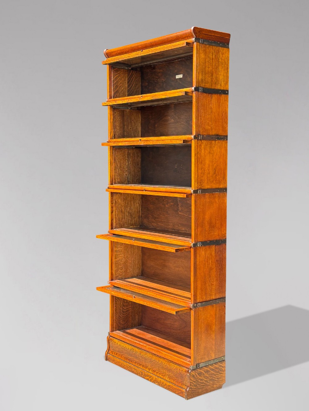 A tall late 19th-century six-tier oak Globe Wernicke bookcase with glazed up-and-over doors. View V