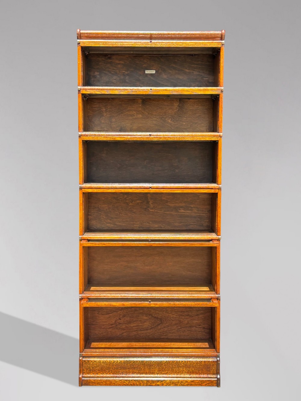 A tall late 19th-century six-tier oak Globe Wernicke bookcase with glazed up-and-over doors. View VI