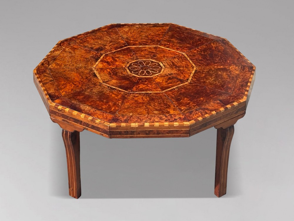 An octagonal 19th-century burr yew wood coffee table featuring radiating veneer panels, a central inlaid star motif, and a checkered border. View II
